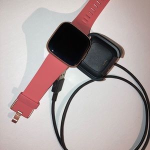 This is a Fitbit versa 2 with a pink wrist band.